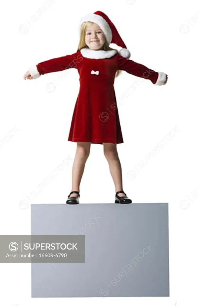 Portrait of a girl standing with her arms outstretched on a blank sign