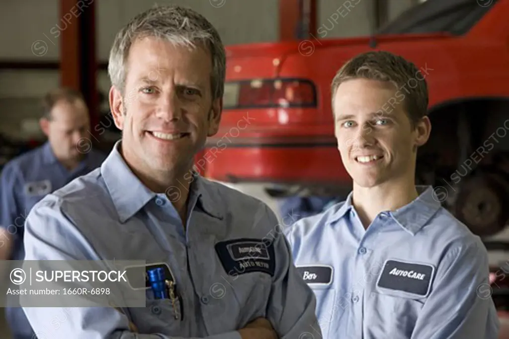 Portrait of two auto mechanics in an auto repair shop