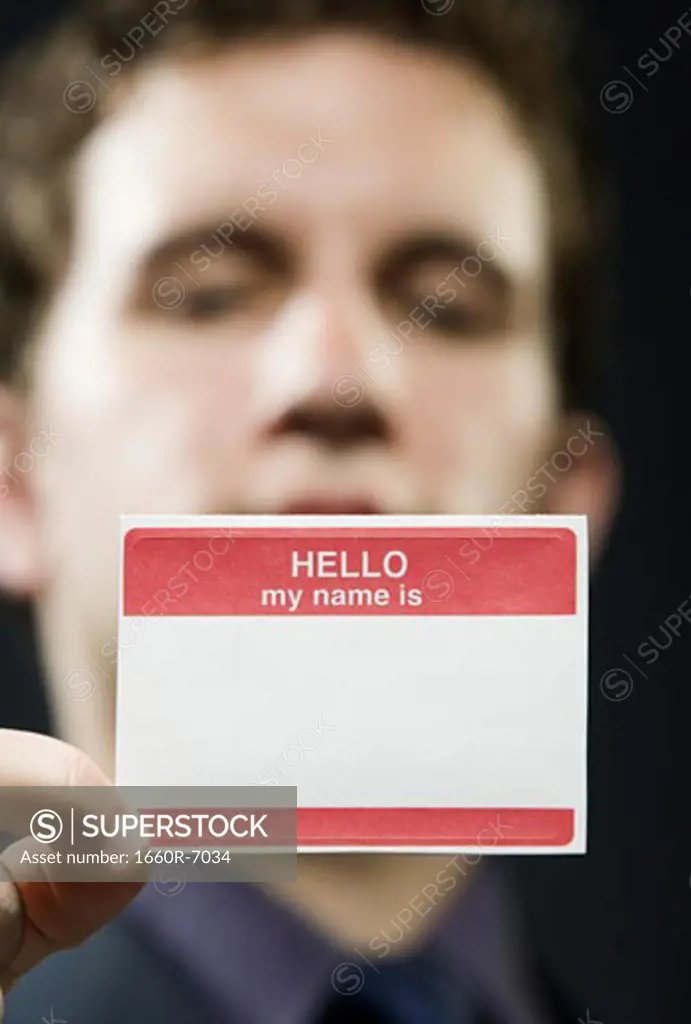 Portrait of a businessman holding a name tag