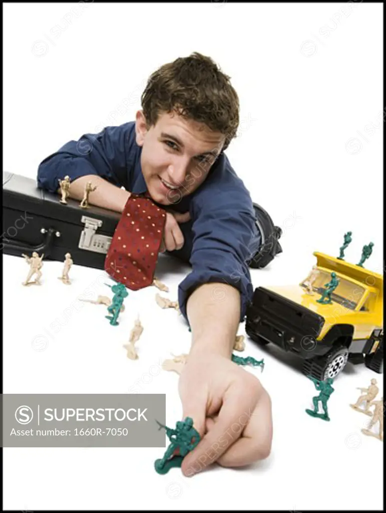 Portrait of a businessman playing with toys