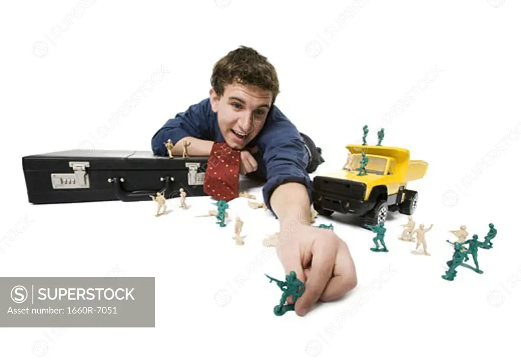 Businessman playing with toys