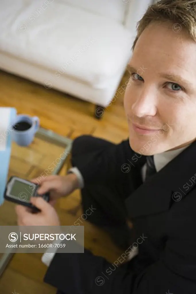 Portrait of a businessman using an electronic organizer