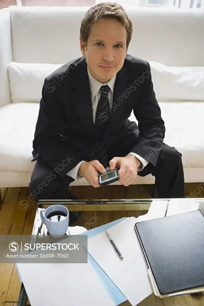 Portrait of a businessman holding an electronic organizer