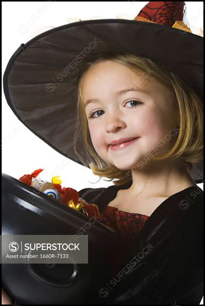 Portrait of a girl holding a bowl of candy