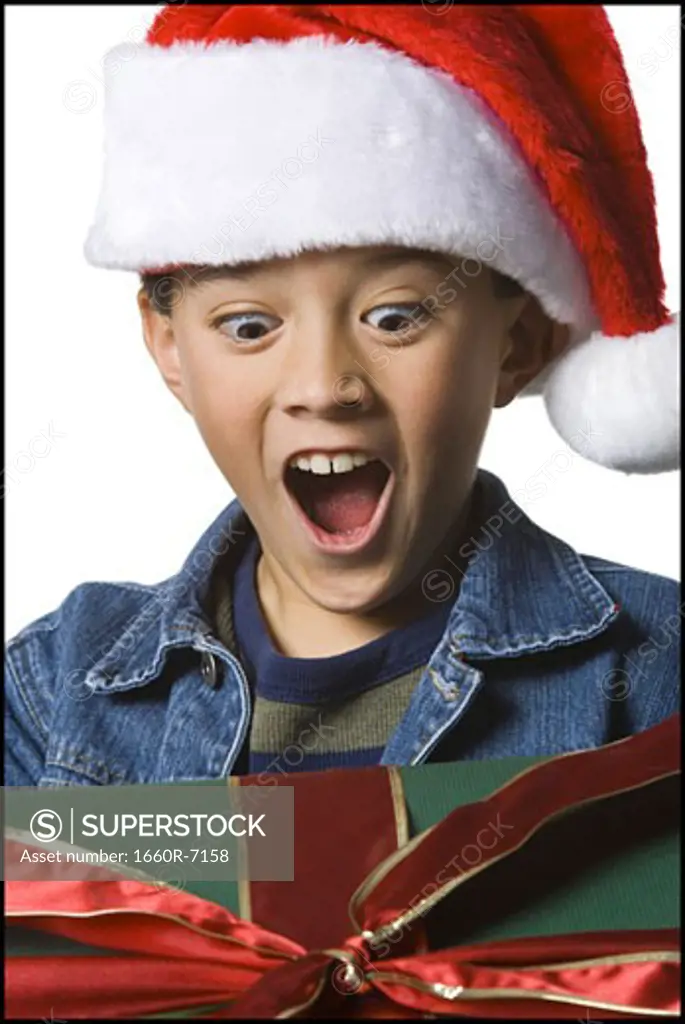 Close-up of a boy looking at a Christmas present