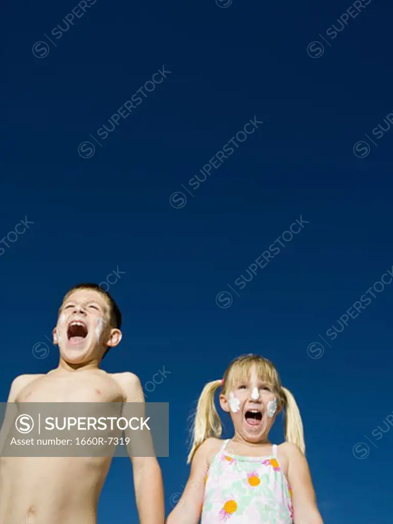 Low angle view of a brother with his sister shouting