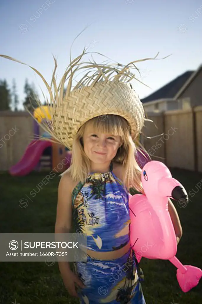 Portrait of a girl holding a pink flamingo