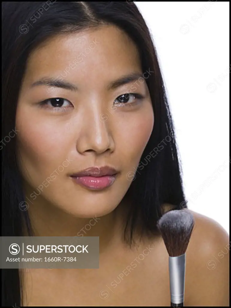 Portrait of a woman with a make-up brush