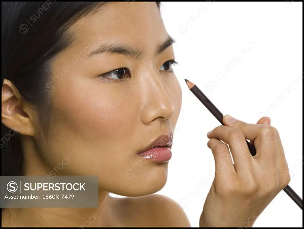 Close-up of a woman applying eyeliner