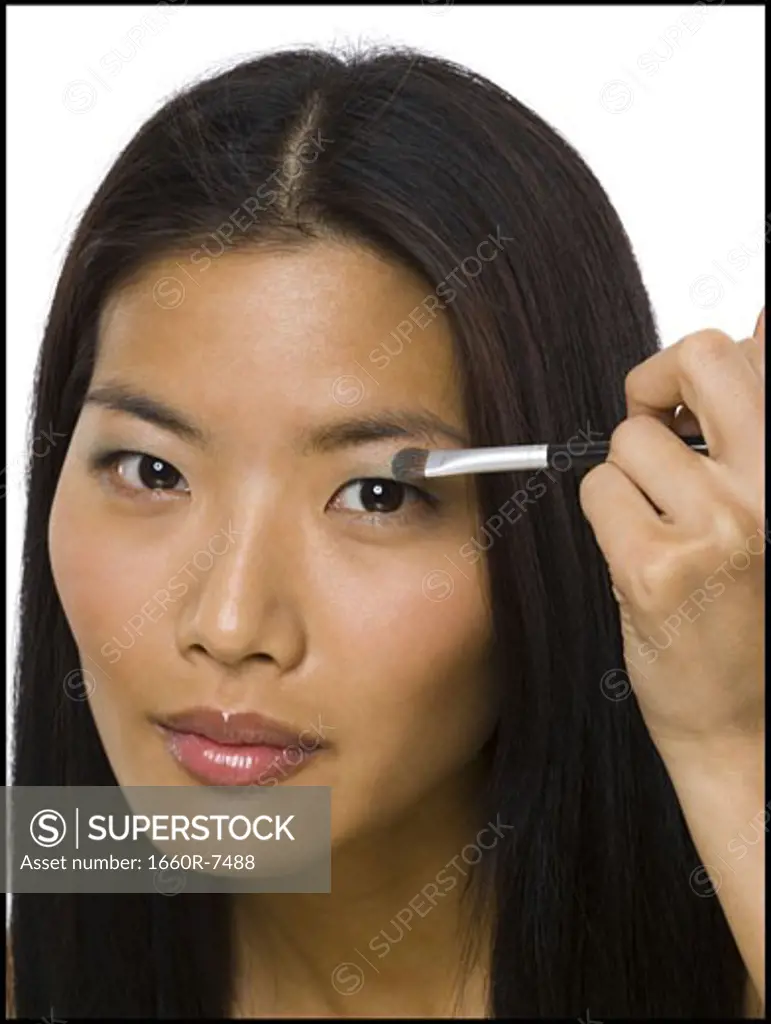 Portrait of a woman applying eyeshadow