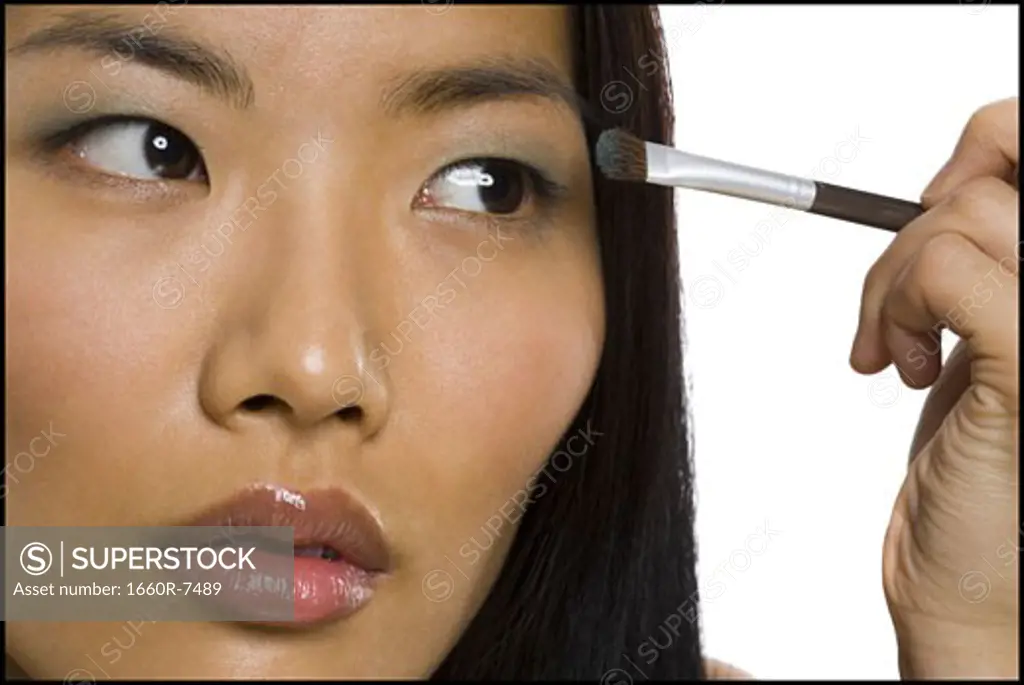 Close-up of a woman applying eyeshadow