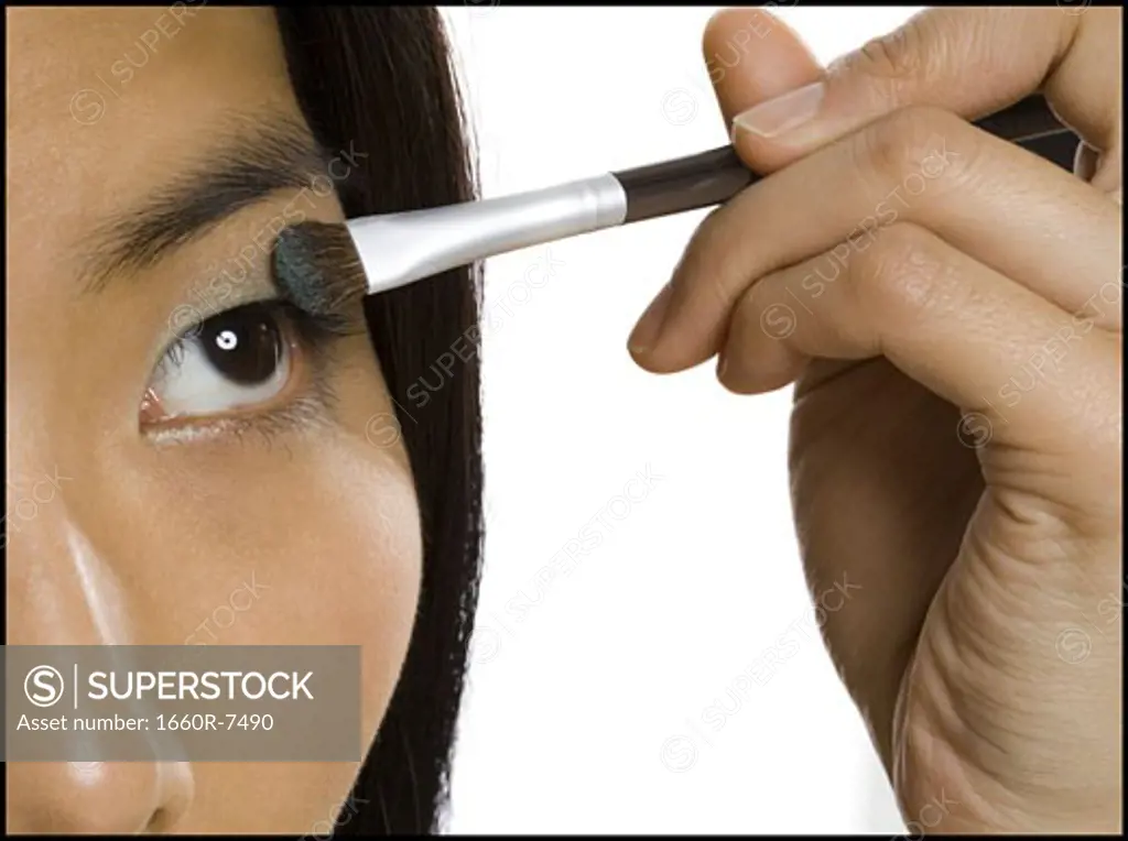 Close-up of a woman applying eyeshadow