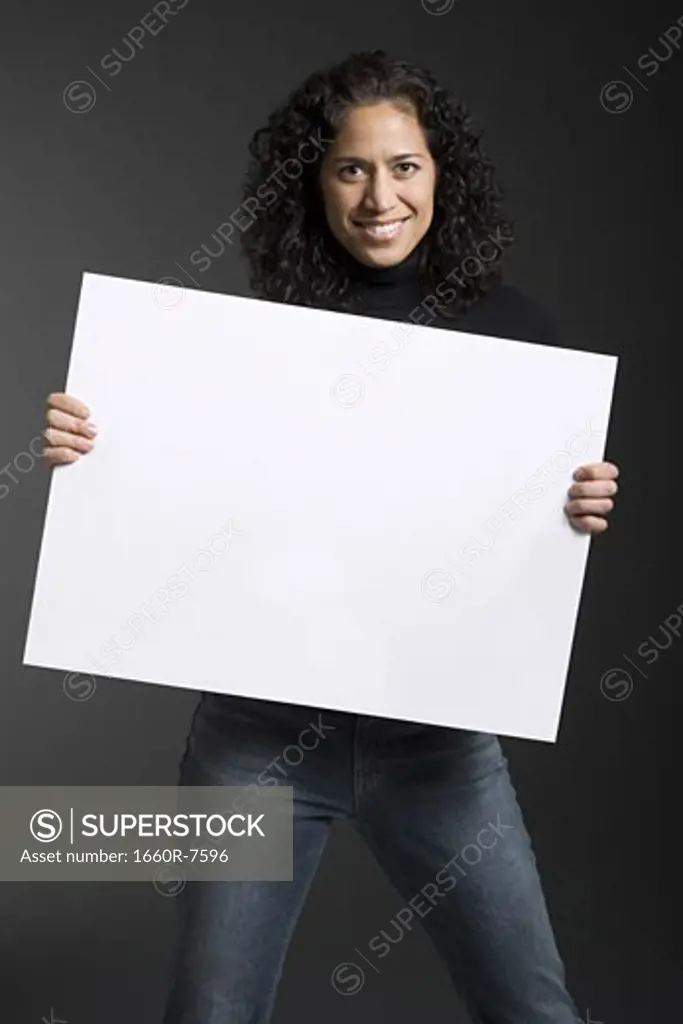 Portrait of a woman holding a blank sign and smiling