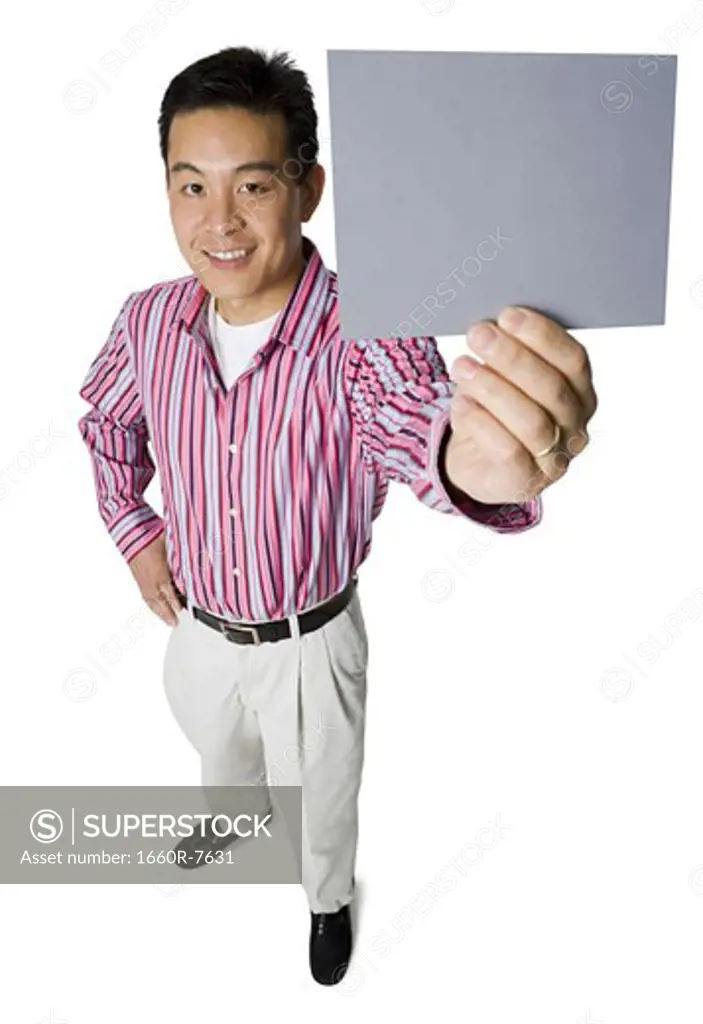 Portrait of a mid adult man holding a blank sign