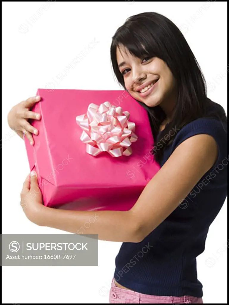 Close-up of a teenage girl holding a gift