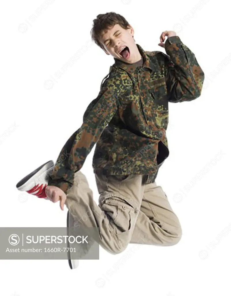 Low angle view of a boy jumping in mid-air