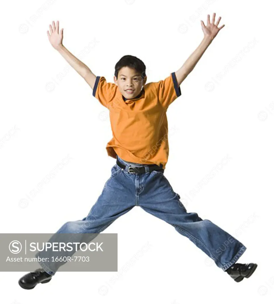 Portrait of a boy jumping with his legs apart