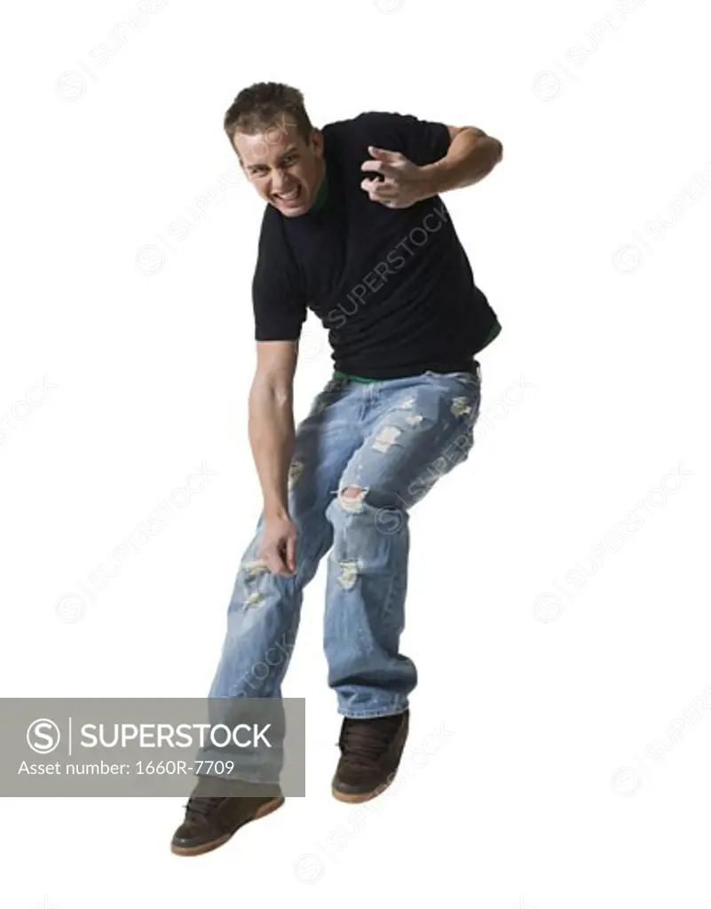 Portrait of a young man jumping in mid-air