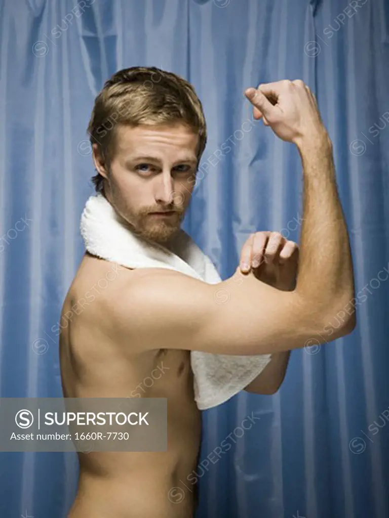 Profile of a young man flexing his biceps