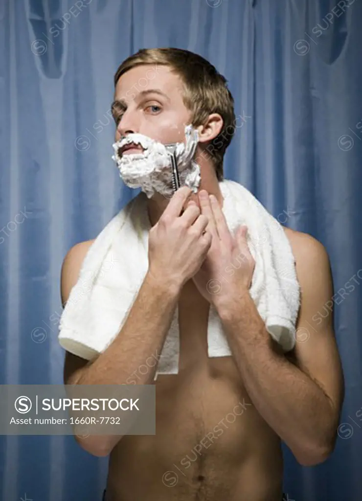 Close-up of a young man shaving