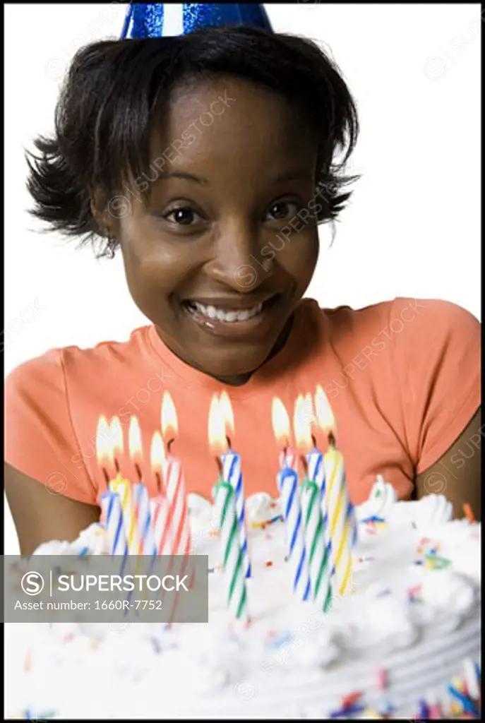 Close-up of a young woman holding a birthday cake