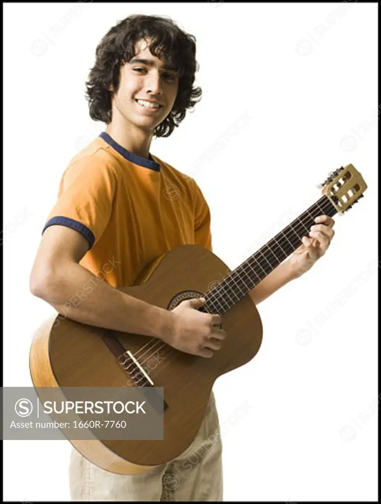 Portrait of a teenage boy playing the guitar