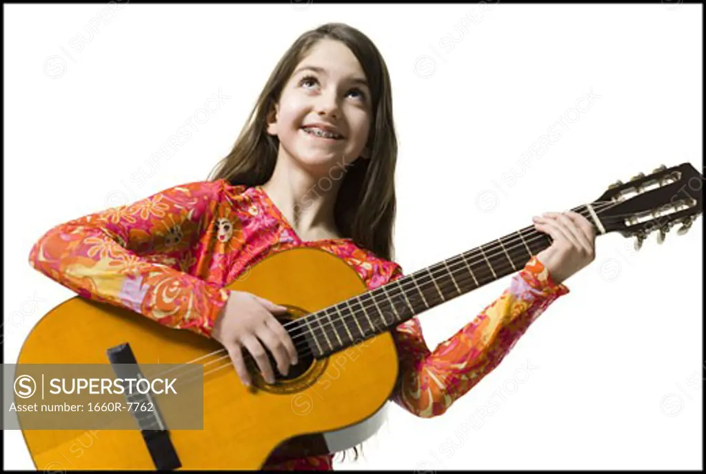 Close-up of a teenage girl holding a guitar