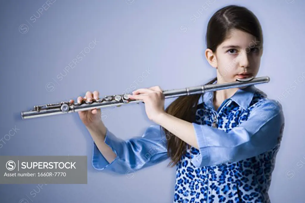 Portrait of a teenage girl playing the flute