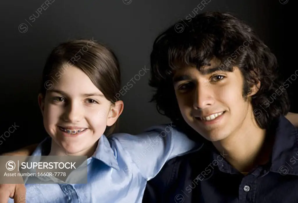 Portrait of teenage siblings smiling