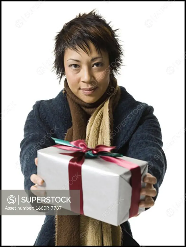 Portrait of a young woman holding a gift