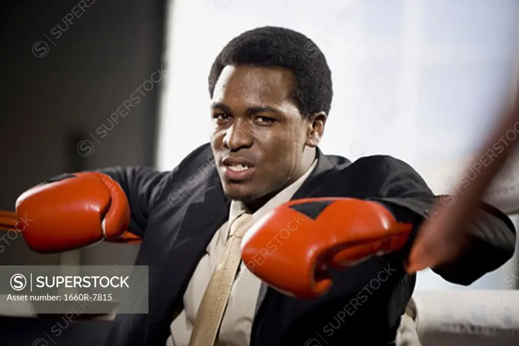 Portrait of a young man sitting in a boxing ring