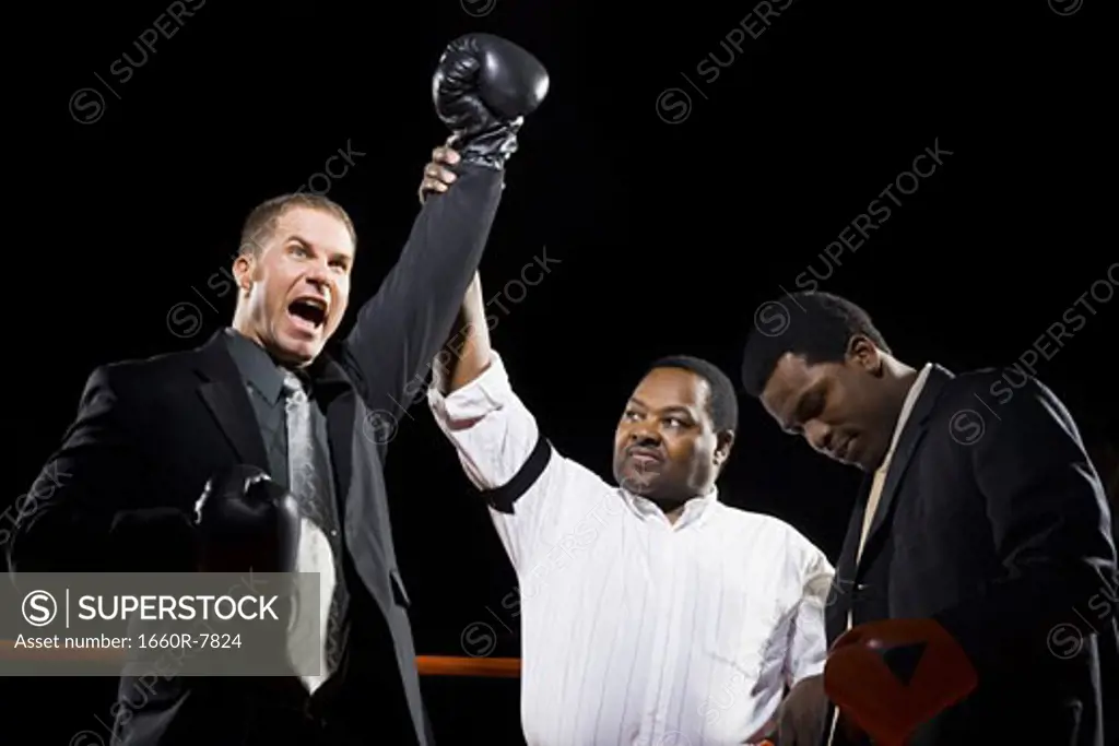 Referee declaring the winner of a boxing match