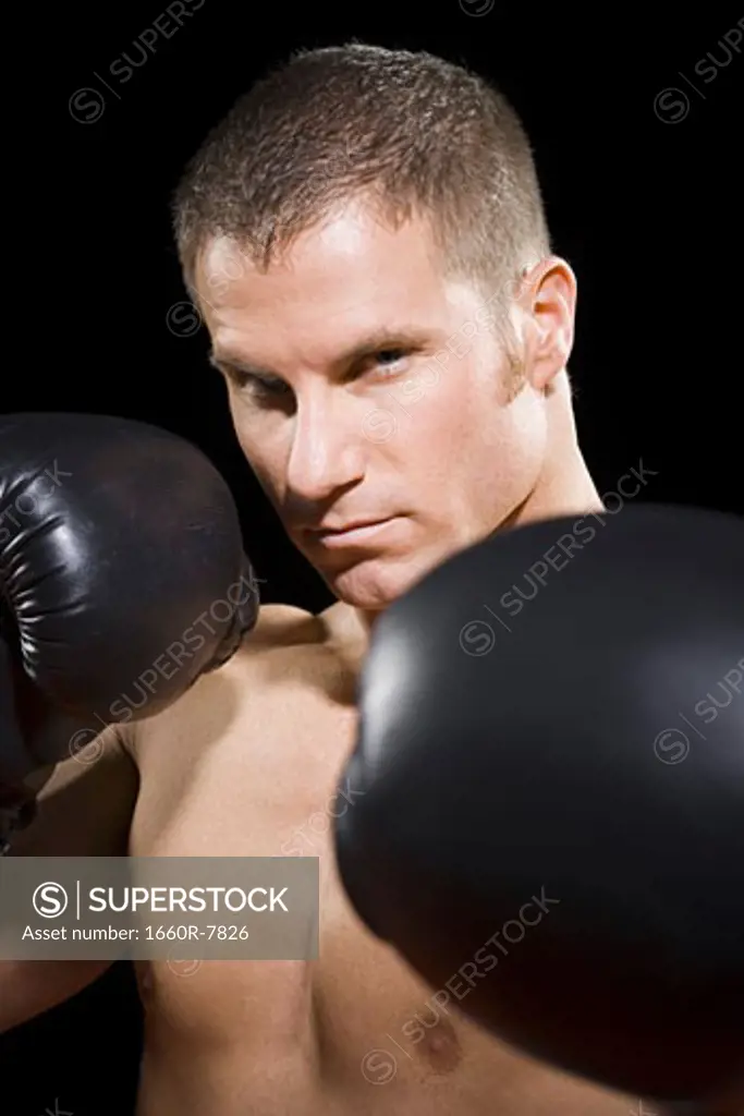 Portrait of a young man boxing