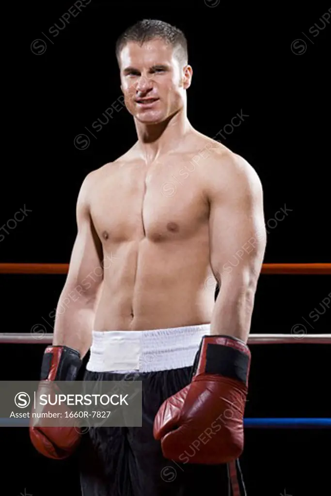 Portrait of a young man standing in a boxing ring
