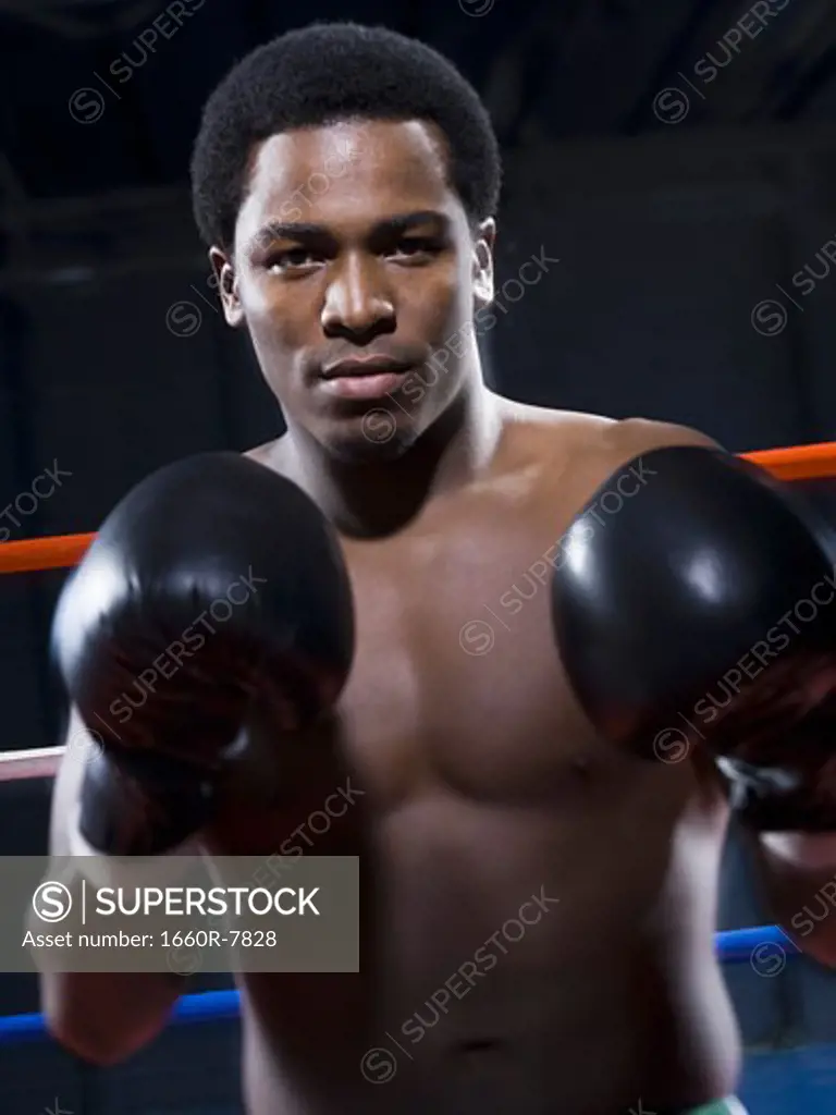 Portrait of a young man boxing