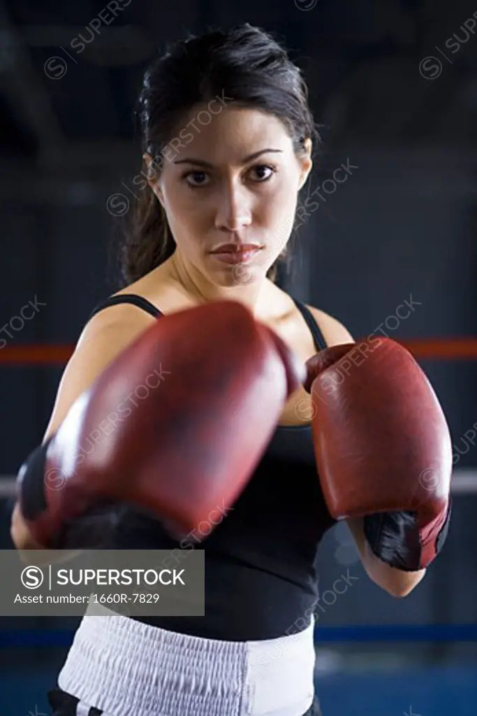 Portrait of a young woman boxing
