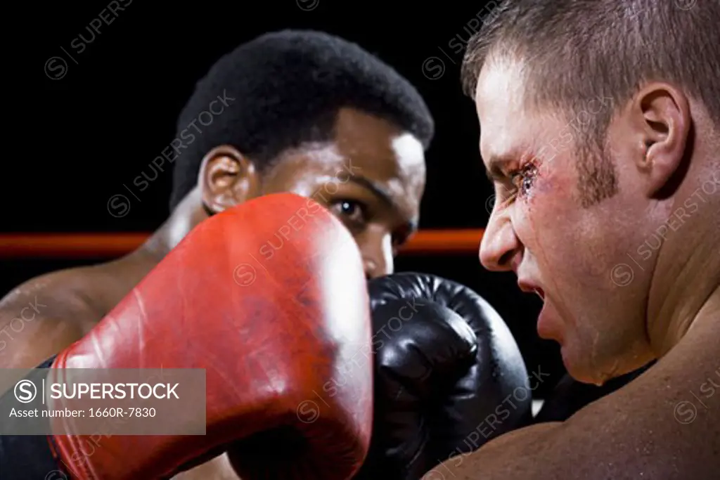 Close-up of two young men fighting in a boxing ring