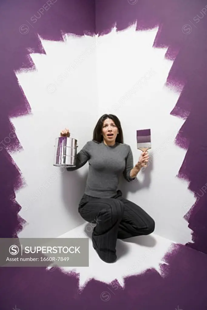 Portrait of a mid adult woman in the corner of a room