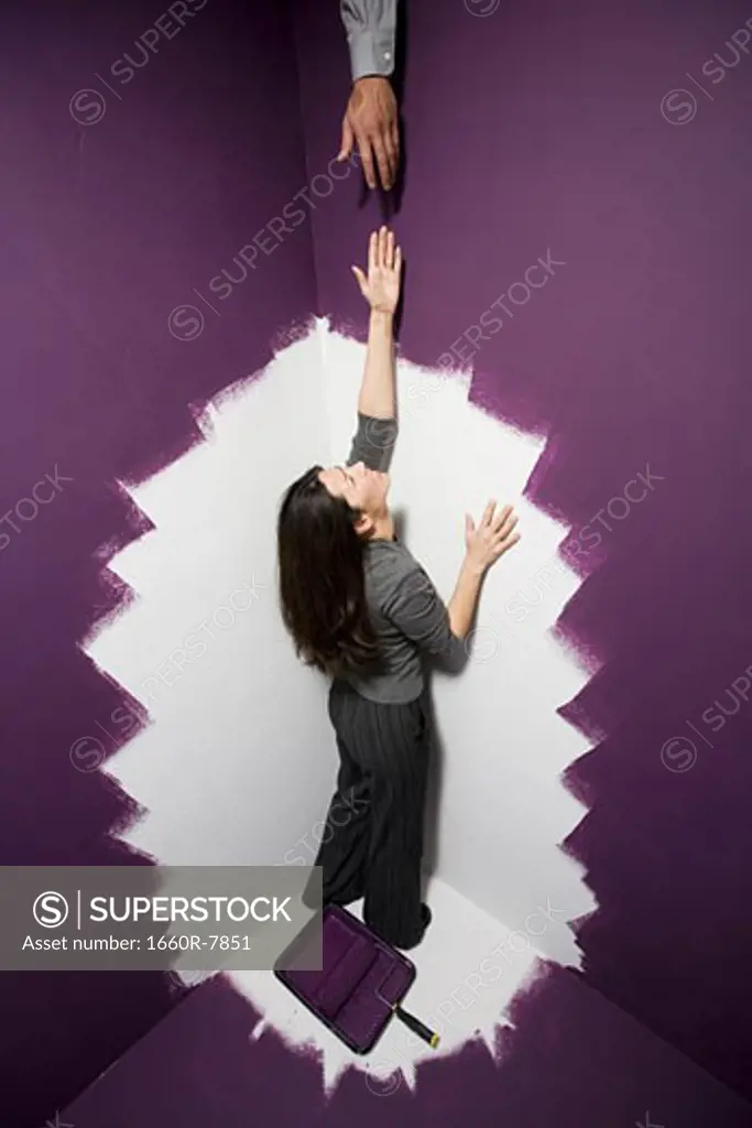 High angle view of a mid adult woman reaching out for a man's hand