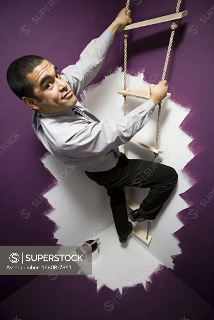 Portrait of a businessman climbing a ladder