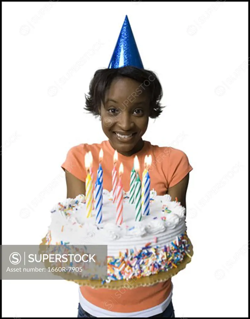 Portrait of a young woman holding a birthday cake