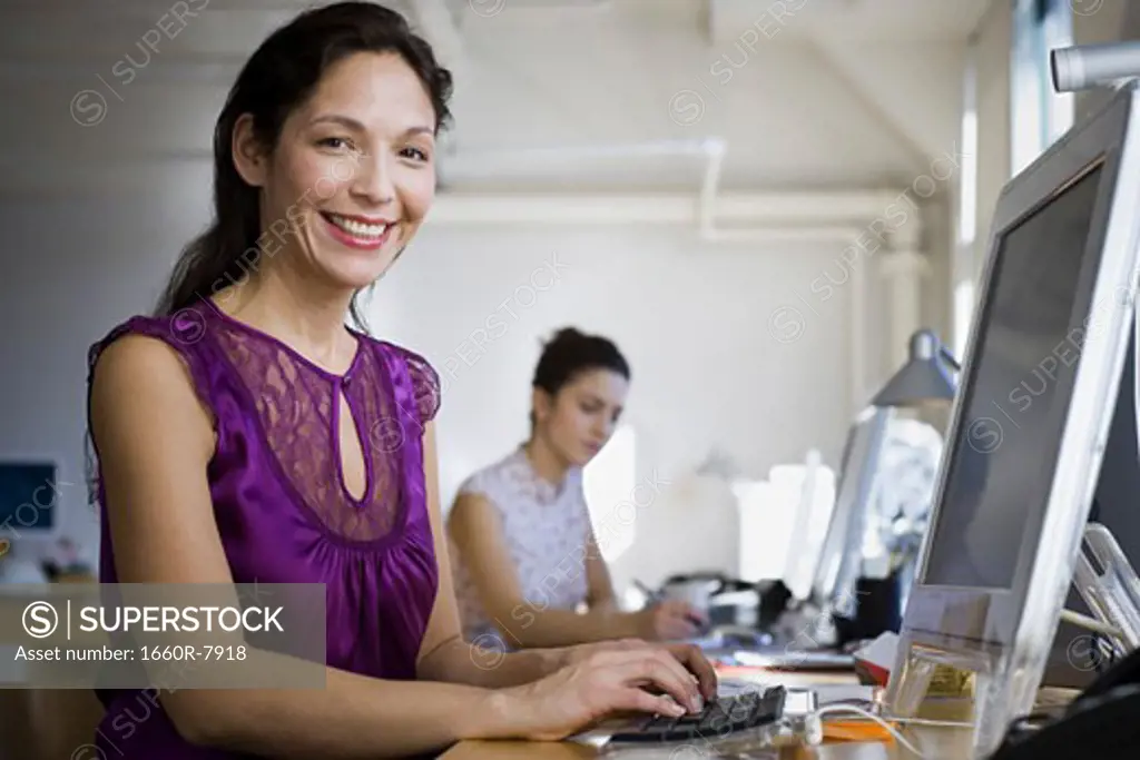 Portrait of a mature woman and a young woman working in an office