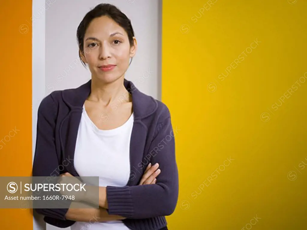 Portrait of a woman standing with her arms folded