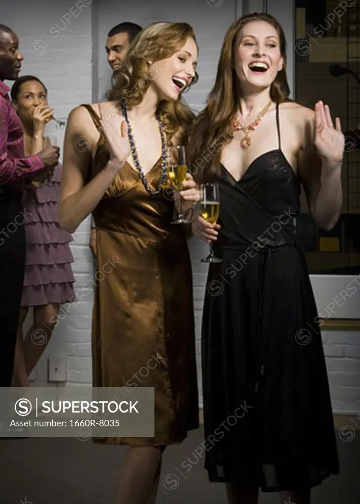 Close-up of two young women smiling at a party