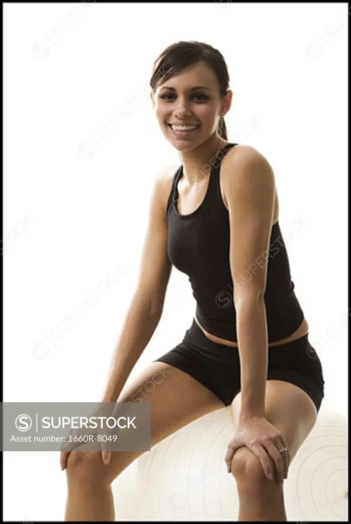 Portrait of a woman sitting on a white fitness ball