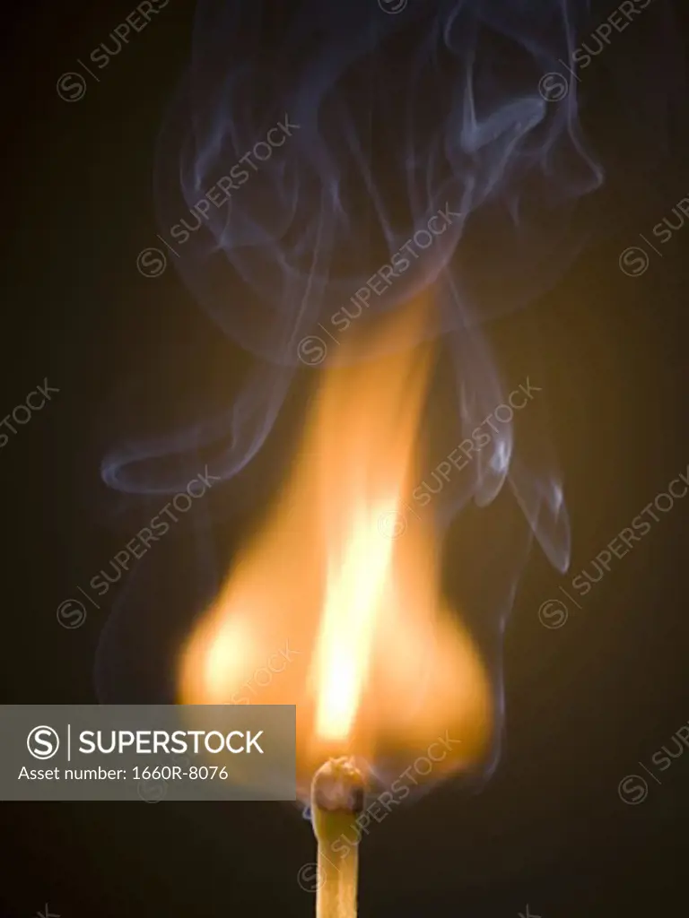 Close-up of a burning matchstick