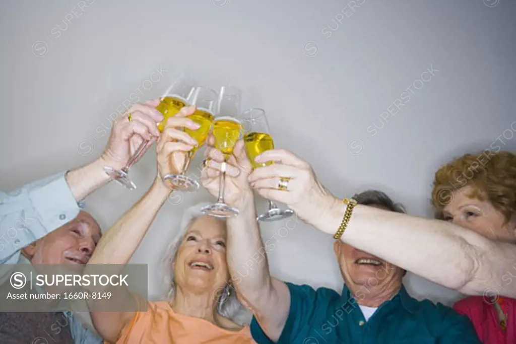 Low angle view of two senior couples making a toast