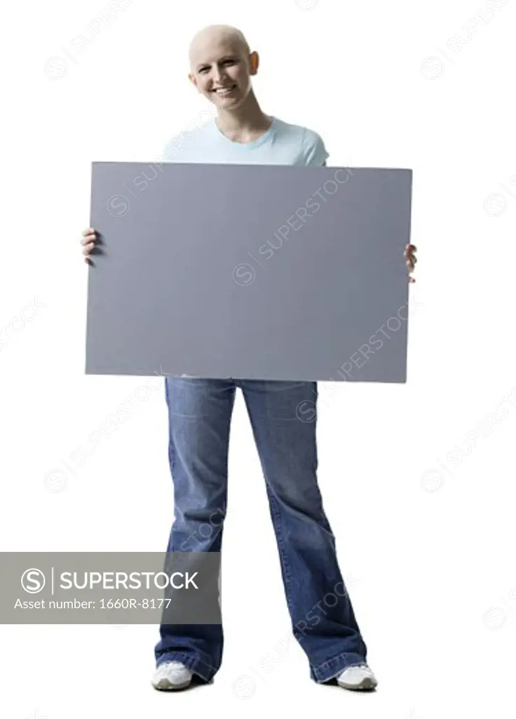 Portrait of a bald young woman holding a blank sign