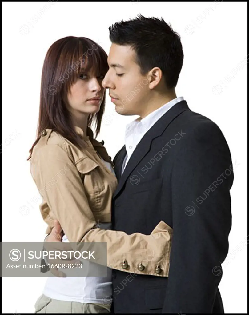 Profile of a young couple embracing each other