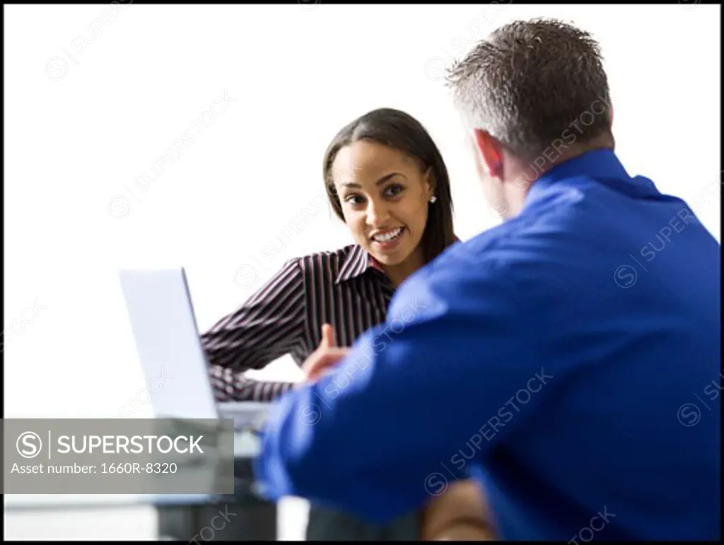 Businesswoman and a businessman discussing